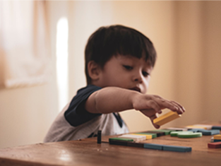 child playing with toy blocks